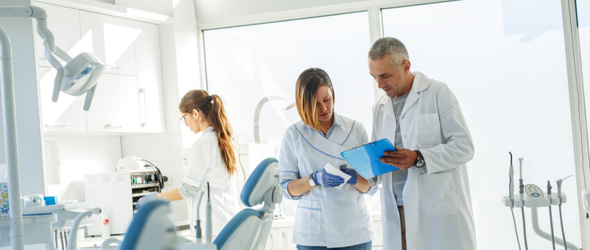 Dental professionals reviewing effective dental marketing strategies offered by Mediboost.